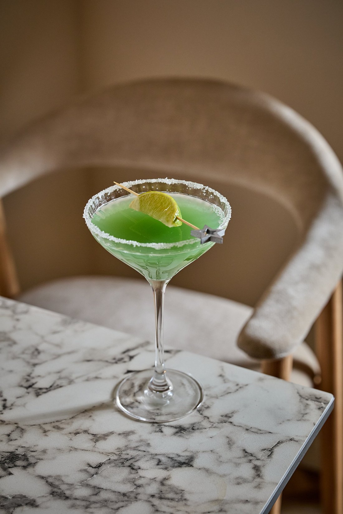 Madame Monsieur green cocktail with a sugared rim and lime garnish in Budapest