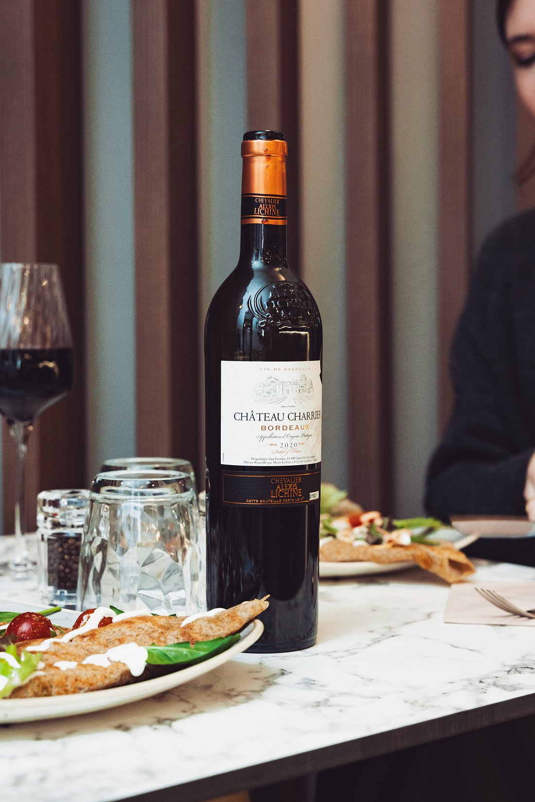 Madame Monsieur French Bordeaux red wine bottle on a marble table in Budapest